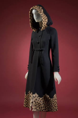 Black wool hooded coat with corded buttons and tassels, cheetah fur trim and shaped hem; matchi…