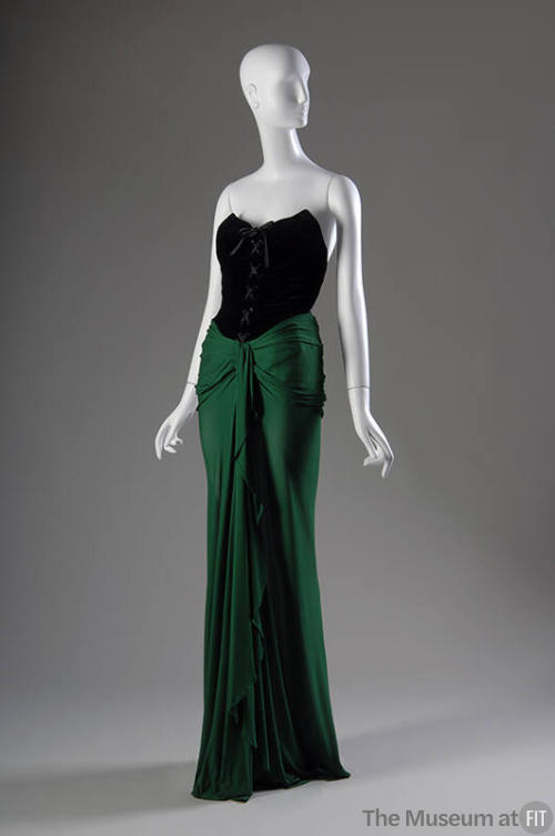 Strapless evening dress with black laced bodice and green floor-length wrap skirt 
