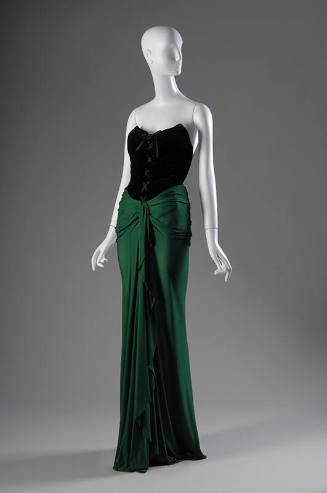 Strapless evening dress with black laced bodice and green floor-length wrap skirt 
