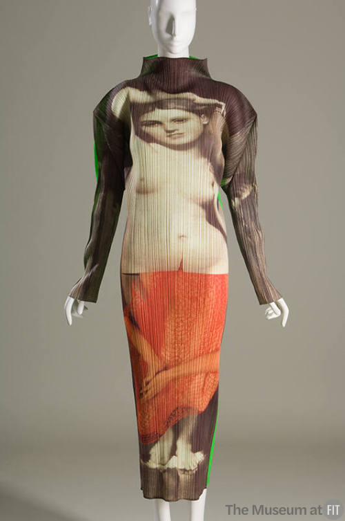 Ankle length long sleeve pleated column dress with beige, brown and orange print of neoclassic …