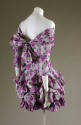 Back view of purple floral off-the-shoulder dress showing bodice that ties at the back and self…
