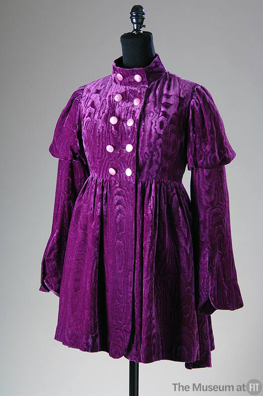 Purple velvet mini coat with watered design, double breasted bodice and bell sleeves with puffe…
