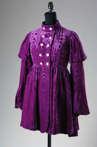 Purple velvet mini coat with watered design, double breasted bodice and bell sleeves with puffe…