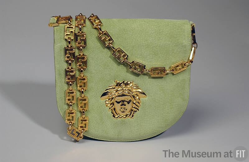 Chartreuse fold over shoulder bag with gold chain link strap and Versace Medusa logo on front