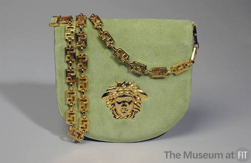 Chartreuse fold over shoulder bag with gold chain link strap and Versace Medusa logo on front