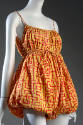 Closer view of red and yellow geometric print romper
