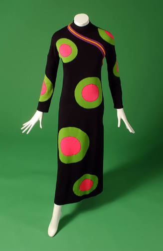 Black floor length long sleeve dress with large concentric hot pink and green circles throughou…