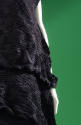 Detail of black crinkle pleated dress fabric