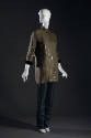 Brown tunic top with metallic stripes and brown fur cuff with black pants