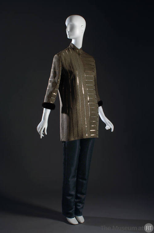 Brown tunic top with metallic stripes and brown fur cuff with black pants