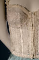 Detail of white bustier with beads and lace trim