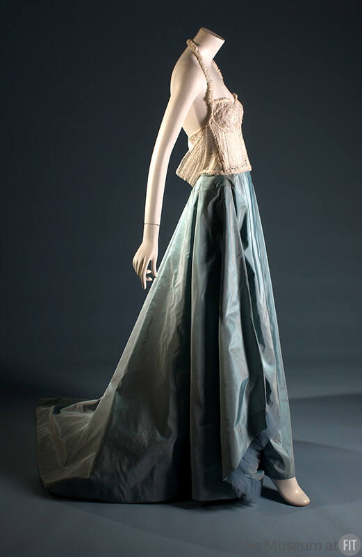 White halter neck bustier with beads over blue taffeta floor length skirt with train 