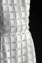 Detail of white openwork square dress fabric 
