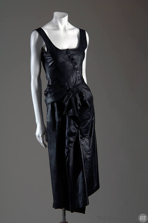 Black leather sleeveless dress with buttoned bodice and asymmetic skirt