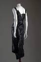 Back view of black leather sleeveless dress with lace-up bodice and asymmetic skirt 