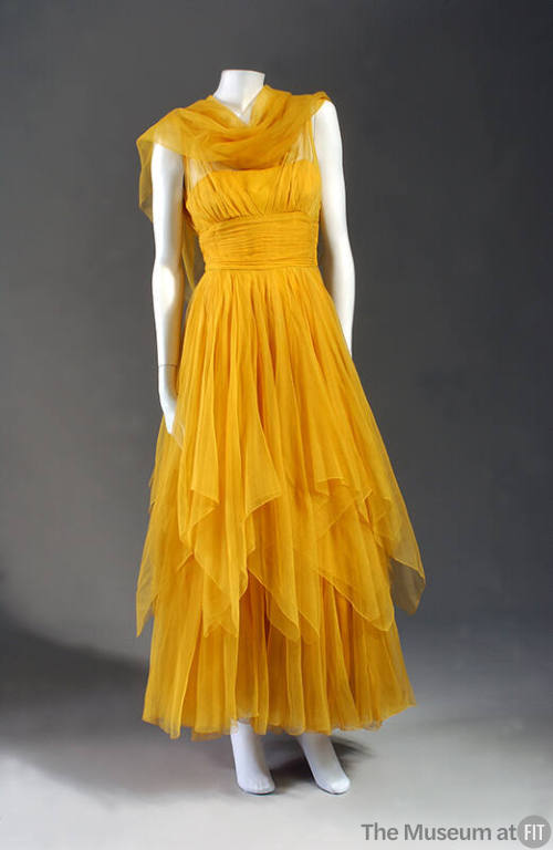 Orange silk chiffon ankle length dress with layered skirt and neck scarf 