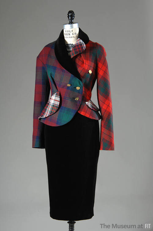 Asymmetrical double-breasted jacket in various red, green, white plaids with black velvet colla…
