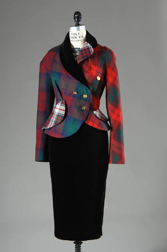 Asymmetrical double-breasted jacket in various red, green, white plaids with black velvet colla…