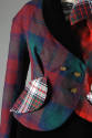 Detail shot of double-breasted jacket in various red, green, white plaids with gold buttons 