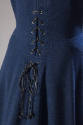 Detail of back black leather lacing of blue dress