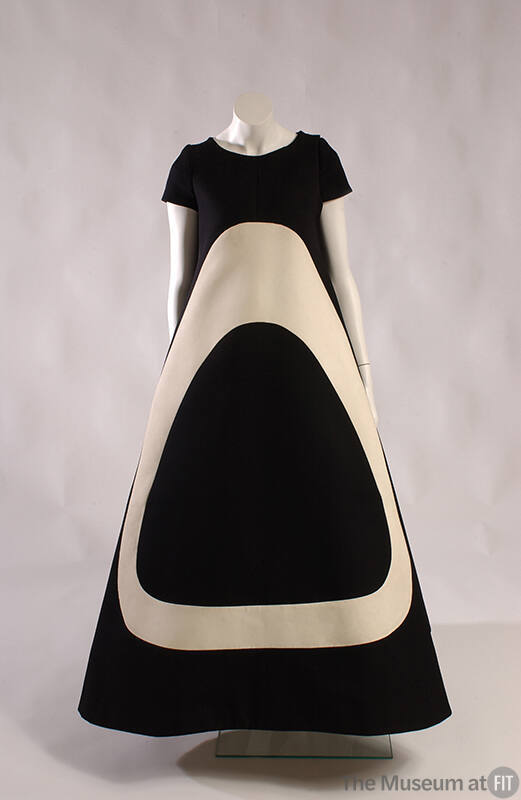 Floor length short sleeve black tent dress with large off-white ovoid shape on front 