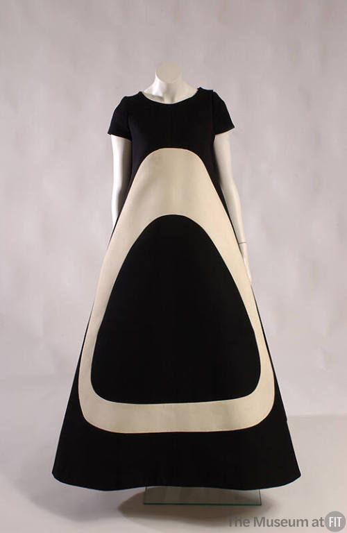 Floor length short sleeve black tent dress with large off-white ovoid shape on front 