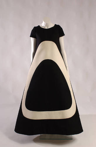 Floor length short sleeve black tent dress with large off-white ovoid shape on front 