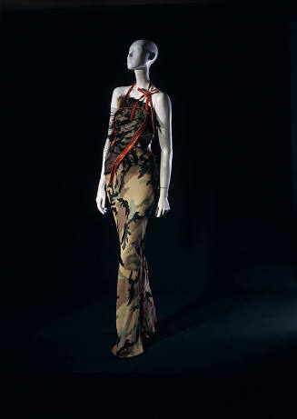 Camouflage halter evening dress with long asymmetrical and large orange plastic zippers for str…