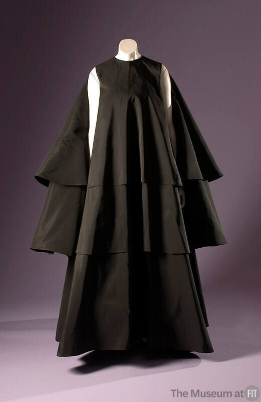 Black long sleeveless evening tent dress with three staggered full circle layers