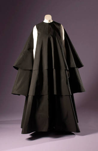 Black long sleeveless evening tent dress with three staggered full circle layers