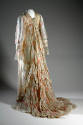 Back view of off-white long sleeve tea gown with bands of lace pieced to form chevron pattern o…