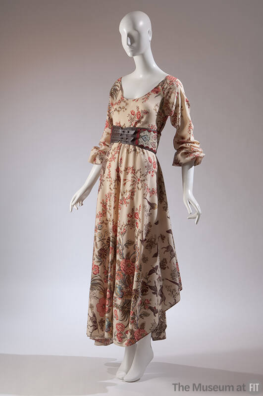 Asymmetrical cream peasant dress with enlarged flower, birds, and dog print with wide belt