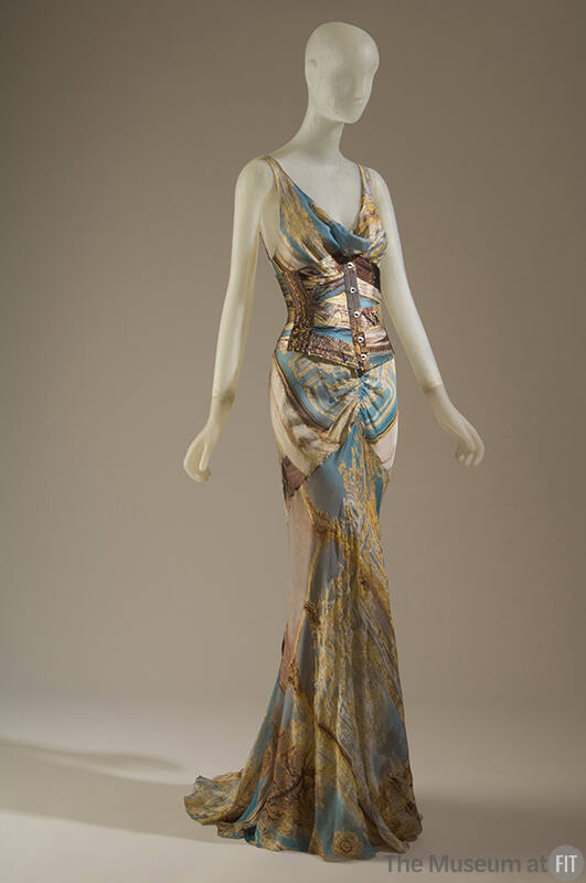 Long, flared evening dress and corset printed with design of gilt baroque frames and red string…