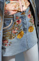 embroidered floral motif on light blue denim micro mini skrit