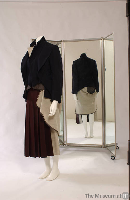 Navy cutaway jacket with attached beige vest lining and dark red skirt