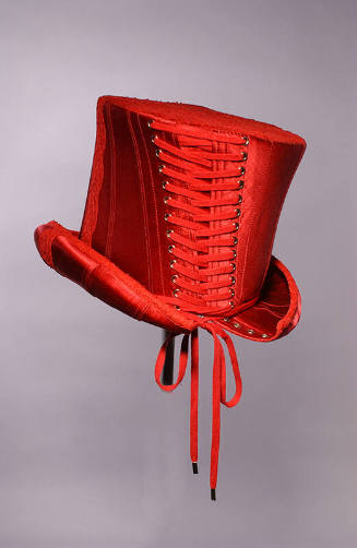 Deep red, tall hat with boned corset construction and flared crown