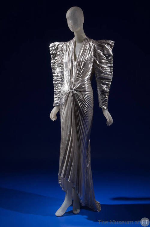 Pleated metallic silver lamé long sleeve dress, futuristic angular styling with wide padded sho…