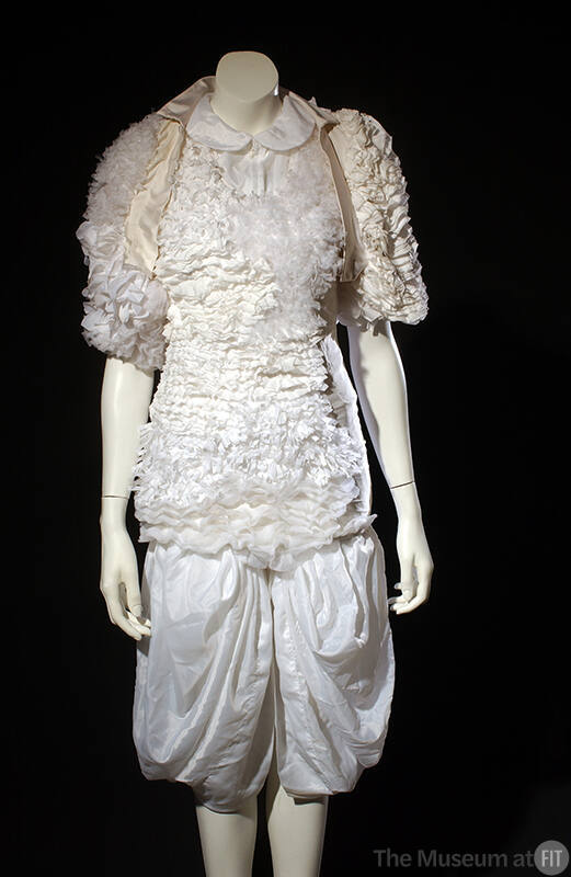 White evening dress and bolero asymmetrically covered with large sheer and small tulle-like ruf…
