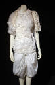 White evening dress and bolero asymmetrically covered with large sheer and small tulle-like ruf…