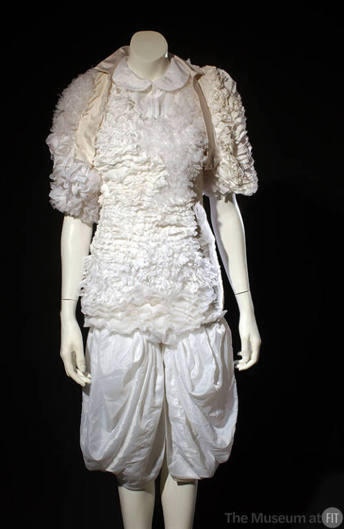 White evening dress and bolero asymmetrically covered with large sheer and small tulle-like ruf…