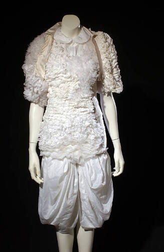 White evening dress and bolero asymmetrically covered with large sheer and small tulle-like ruf…