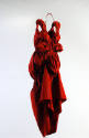 Red, sleeveless, evening dress tapered to ankle length with asymmetrically draped bubble skirt …