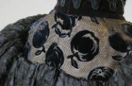 Detail of black velvet apple motif on back of dress