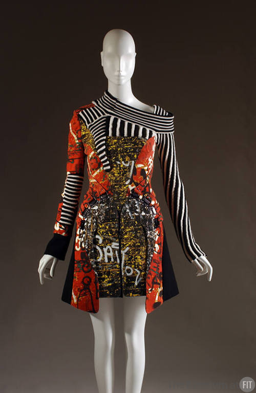 Red, yellow, and black graffiti mini dress with black and white striped, asymmetrical neckline …