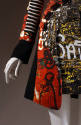 Detail of black, red, and white graffiti dress, black and white striped long sleeve