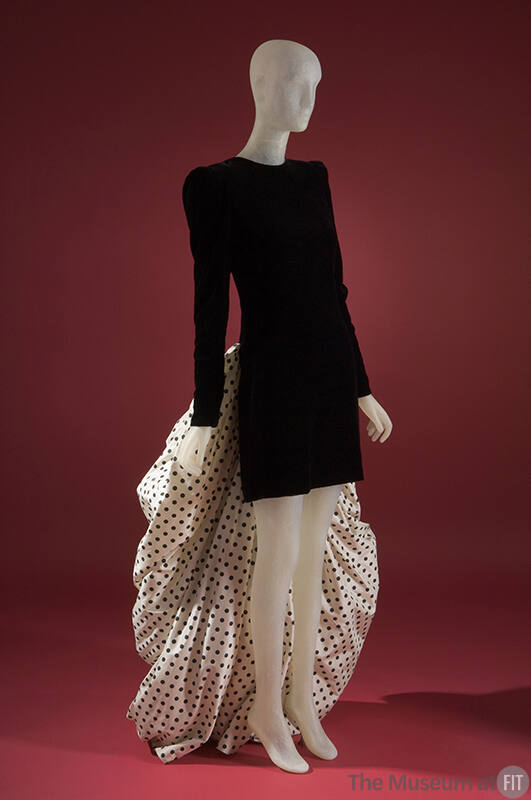 Black, long sleeved mini sheath cocktail dress; white with black polka dot train attached 