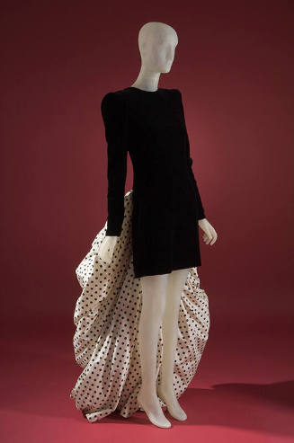 Black, long sleeved mini sheath cocktail dress; white with black polka dot train attached 