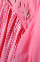 close up of white gingham shirred panel with stitched pink fabric on skirt