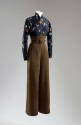 Chinoiserie blouse with scattered black seed beads in floral pattern and tan straightleg pants …