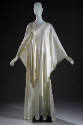 Alternate view of white caftan dress with gathered knotted shoulder and asymmetrical hem